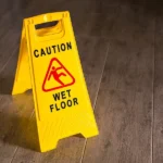 Wet floor sign on wooden floor